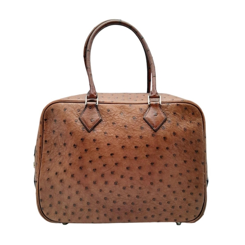 46 - A Hermes Plume 28 Ostrich Bag. Brown ostrich leather exterior with silver-toned hardware, two rolled... 