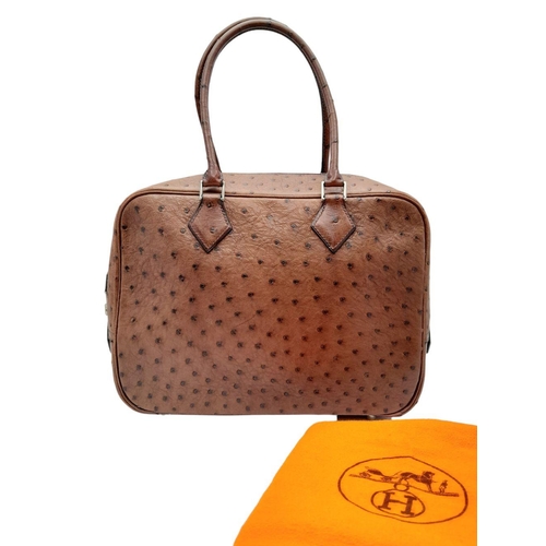 46 - A Hermes Plume 28 Ostrich Bag. Brown ostrich leather exterior with silver-toned hardware, two rolled... 