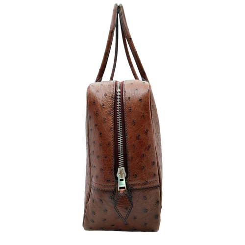 46 - A Hermes Plume 28 Ostrich Bag. Brown ostrich leather exterior with silver-toned hardware, two rolled... 