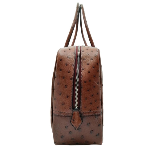 46 - A Hermes Plume 28 Ostrich Bag. Brown ostrich leather exterior with silver-toned hardware, two rolled... 