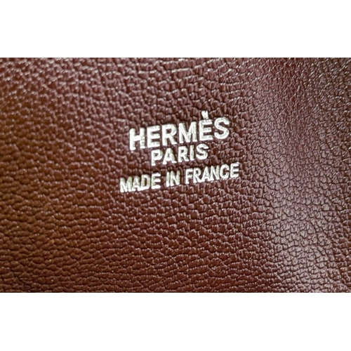 46 - A Hermes Plume 28 Ostrich Bag. Brown ostrich leather exterior with silver-toned hardware, two rolled... 