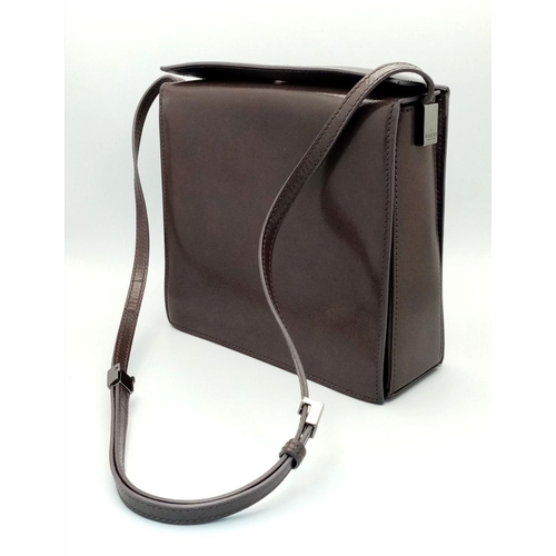 473 - A Gucci Brown Leather Crossbody Bag. Brown leather exterior with gold-toned hardware and a magnetic ... 