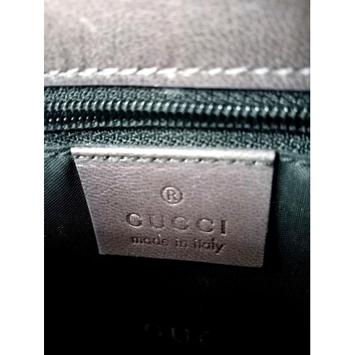 473 - A Gucci Brown Leather Crossbody Bag. Brown leather exterior with gold-toned hardware and a magnetic ... 