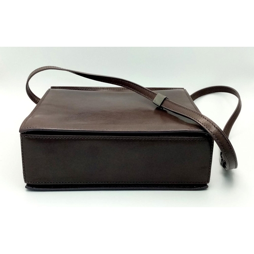 473 - A Gucci Brown Leather Crossbody Bag. Brown leather exterior with gold-toned hardware and a magnetic ... 