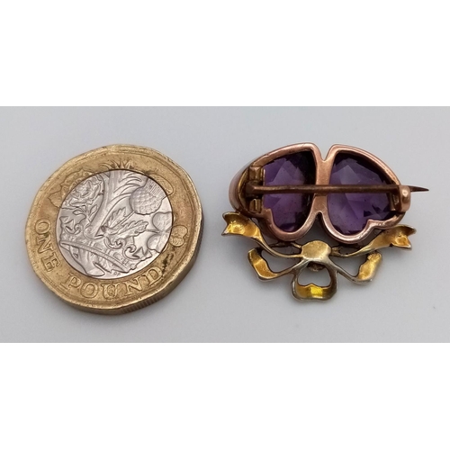 48 - An Antique 9K Gold (tested), Amethyst and Seed Pearl Brooch. Twin amethyst hearts. 3 x 2cm. Pin has ... 