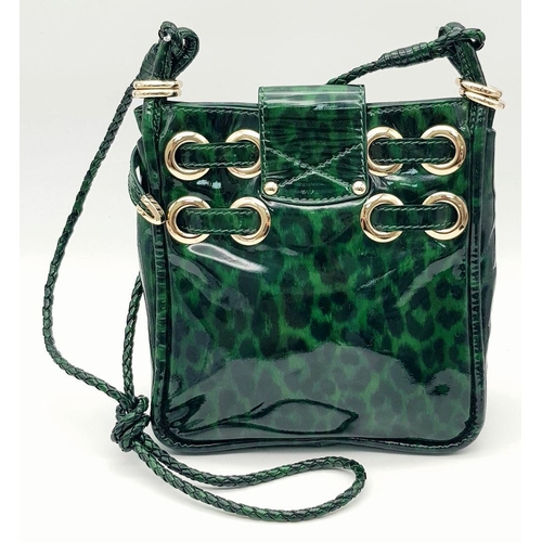 536 - A Jimmy Choo Green Leopard Print Shoulder Bag. Gold tone hardware. Soft textile interior with zipped... 