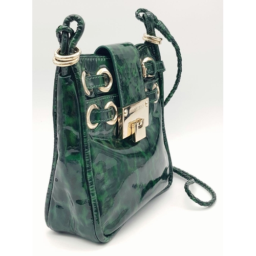 536 - A Jimmy Choo Green Leopard Print Shoulder Bag. Gold tone hardware. Soft textile interior with zipped... 