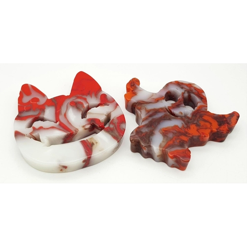 548 - Two Ghoulish Hand-Carved Red and White Coloured Agate Figures. Cheshire cat and ghost!  8 x 8cm.