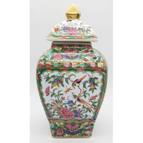 563 - A Large Famille Rose Antique Chinese Vase with Lid. Vibrant colours depicting birds, butterflies, fl... 