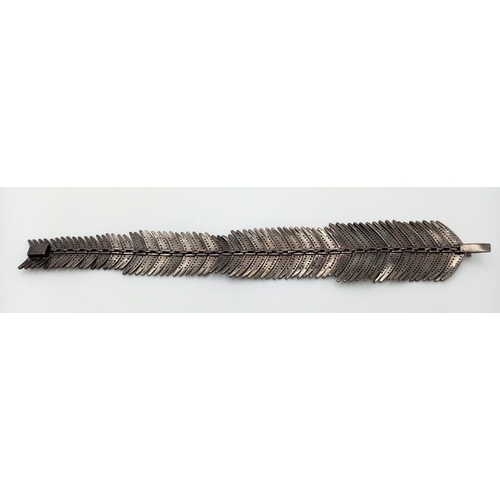 62 - A vintage – or possibly older- silver bracelet in the shape of a feather and covered with old cut di... 