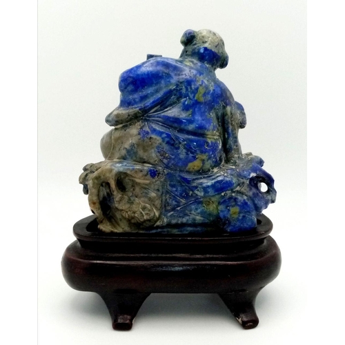 654 - An Early 20th Century Chinese Hand-Carved Lapis Lazuli Deity Figure. Comes with a wooden stand. 8cm ... 