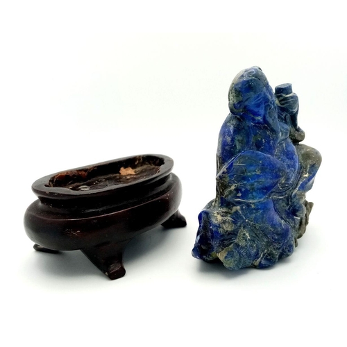 654 - An Early 20th Century Chinese Hand-Carved Lapis Lazuli Deity Figure. Comes with a wooden stand. 8cm ... 