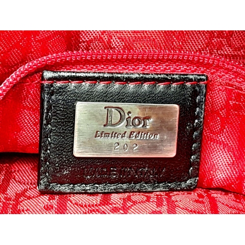 66 - A Christian Dior Faux Fur Shoulder Bag with Hanging Tassels. Silver tone hardware. Red textile inter... 