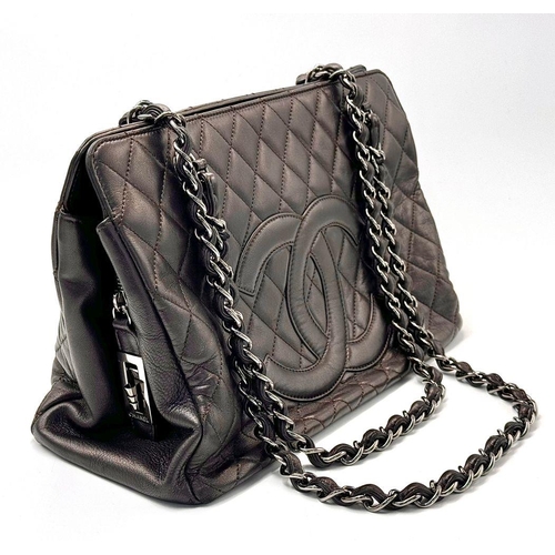 73 - A Chanel Charcoal Grey Shoulder Bag. Quilted leather exterior with Chanel monogram. Silver tone hard... 