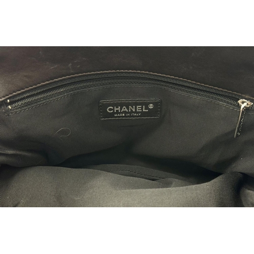 73 - A Chanel Charcoal Grey Shoulder Bag. Quilted leather exterior with Chanel monogram. Silver tone hard... 