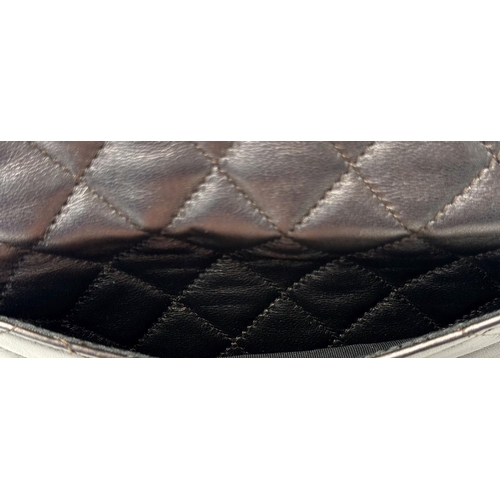 73 - A Chanel Charcoal Grey Shoulder Bag. Quilted leather exterior with Chanel monogram. Silver tone hard... 