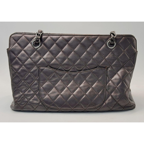 73 - A Chanel Charcoal Grey Shoulder Bag. Quilted leather exterior with Chanel monogram. Silver tone hard... 