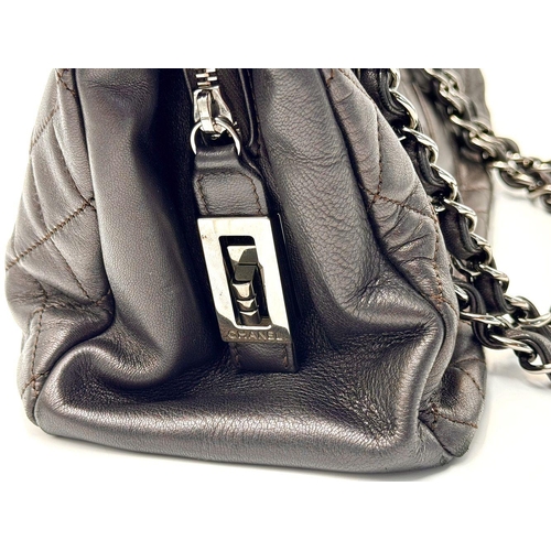 73 - A Chanel Charcoal Grey Shoulder Bag. Quilted leather exterior with Chanel monogram. Silver tone hard... 