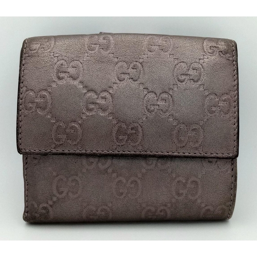 731 - A Gucci Decorative Monogram Purse/Wallet. Metallic effect leather. 12cm x 10cm. Ref: 019387