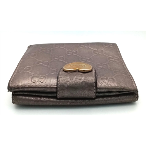 731 - A Gucci Decorative Monogram Purse/Wallet. Metallic effect leather. 12cm x 10cm. Ref: 019387