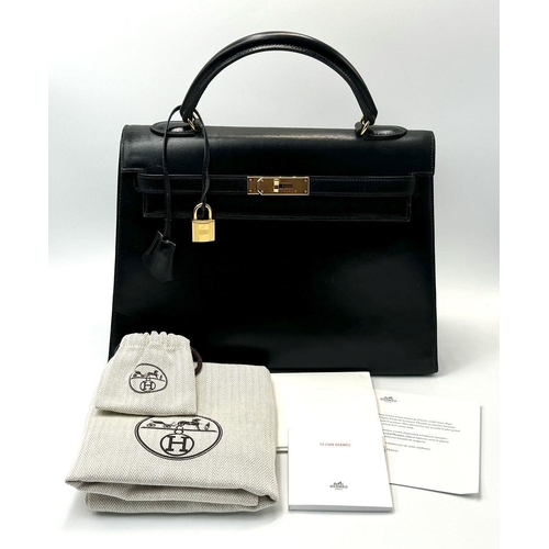 80 - A Hermès Box Kelly Sellier 32 Handbag. Black smooth calfskin leather exterior with gold-toned hardwa... 