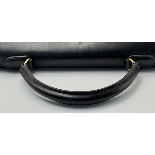 80 - A Hermès Box Kelly Sellier 32 Handbag. Black smooth calfskin leather exterior with gold-toned hardwa... 