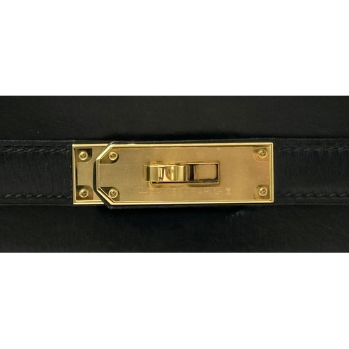 80 - A Hermès Box Kelly Sellier 32 Handbag. Black smooth calfskin leather exterior with gold-toned hardwa... 