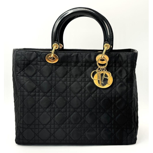 87 - A Christian Dior Black Quilted Tote Bag. Quilted fabric exterior with gold-toned hardware, rolled le... 