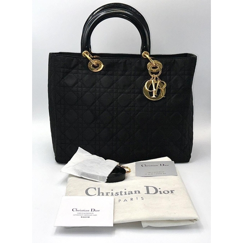 87 - A Christian Dior Black Quilted Tote Bag. Quilted fabric exterior with gold-toned hardware, rolled le... 