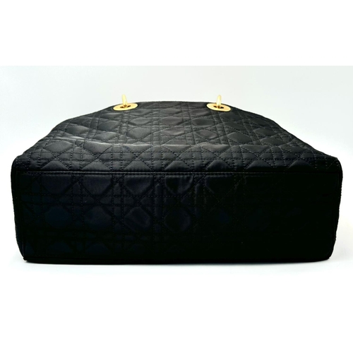 87 - A Christian Dior Black Quilted Tote Bag. Quilted fabric exterior with gold-toned hardware, rolled le... 