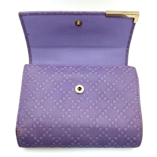 871 - A Gucci Purple Leather Purse/Wallet. Textured exterior. 14cm x 11cm. Ref: 019383