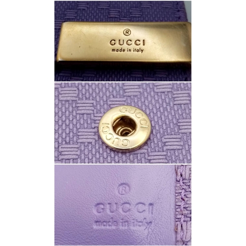 871 - A Gucci Purple Leather Purse/Wallet. Textured exterior. 14cm x 11cm. Ref: 019383