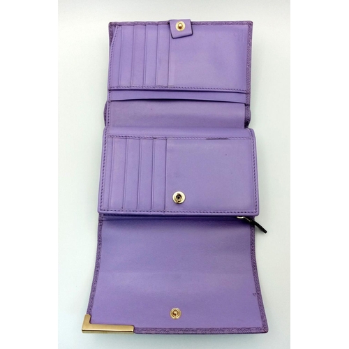 871 - A Gucci Purple Leather Purse/Wallet. Textured exterior. 14cm x 11cm. Ref: 019383