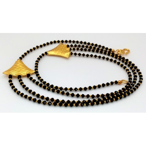 90 - A very elegant and sophisticated, gold plated, necklace and earrings set with three rows of hand cra... 