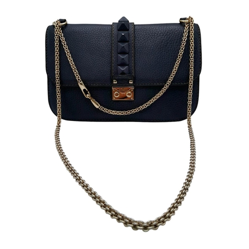 94 - A Valentino Dark Blue Leather Crossbody Bag. Textured exterior with Pyramid stud decoration and gold... 