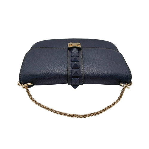 94 - A Valentino Dark Blue Leather Crossbody Bag. Textured exterior with Pyramid stud decoration and gold... 