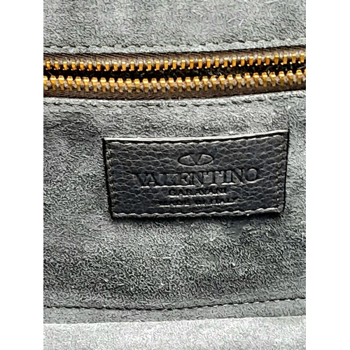 94 - A Valentino Dark Blue Leather Crossbody Bag. Textured exterior with Pyramid stud decoration and gold... 