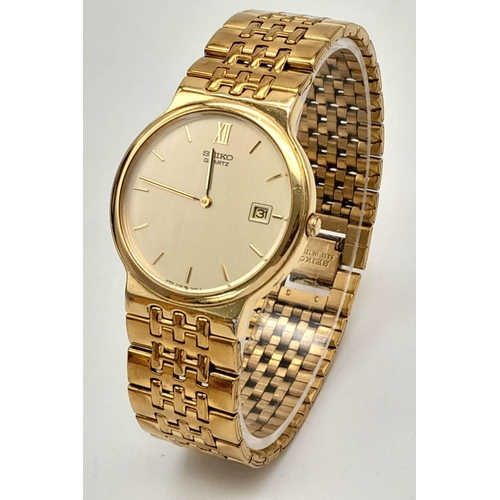 1453 - A Vintage Gold Tone Seiko Model 5Y39-7A40 Quartz Date Watch-34mm Case. Inscription on case back. New... 