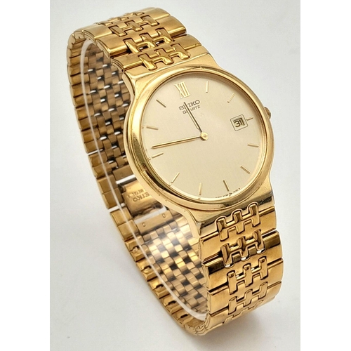 1453 - A Vintage Gold Tone Seiko Model 5Y39-7A40 Quartz Date Watch-34mm Case. Inscription on case back. New... 