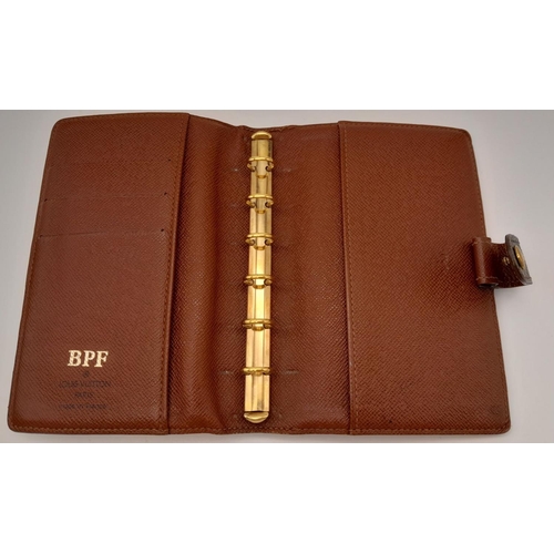 1383 - A Louis Vuitton Agenda/Planner Cover. Monogram coated canvas exterior with gold-toned hardware and p... 