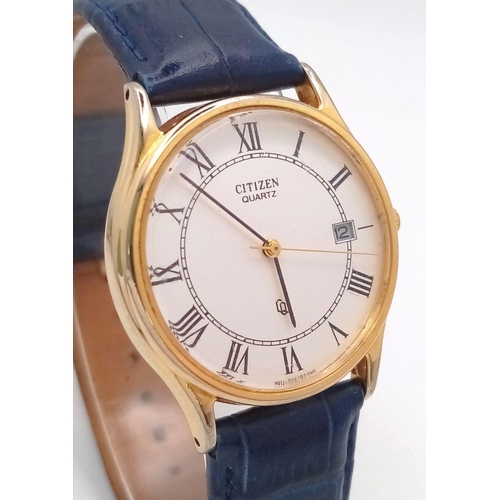 1390 - A Citizen Quartz Gents Watch. Blue leather strap. Gilded case - 32mm. White dial with date window. I... 