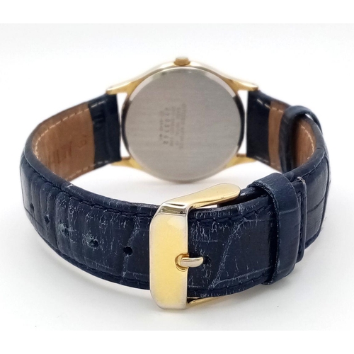 1390 - A Citizen Quartz Gents Watch. Blue leather strap. Gilded case - 32mm. White dial with date window. I... 