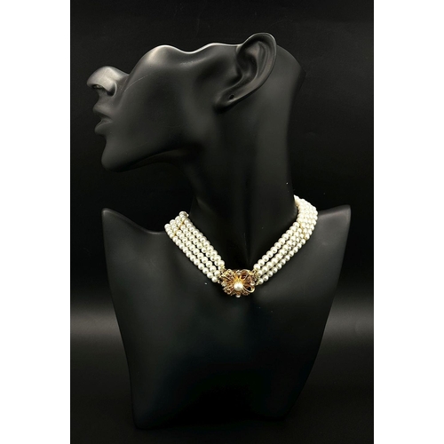 1380 - A very feminine and stylish PIERRE CARDIN three strand faux pearl chocker necklace with a very ornat... 