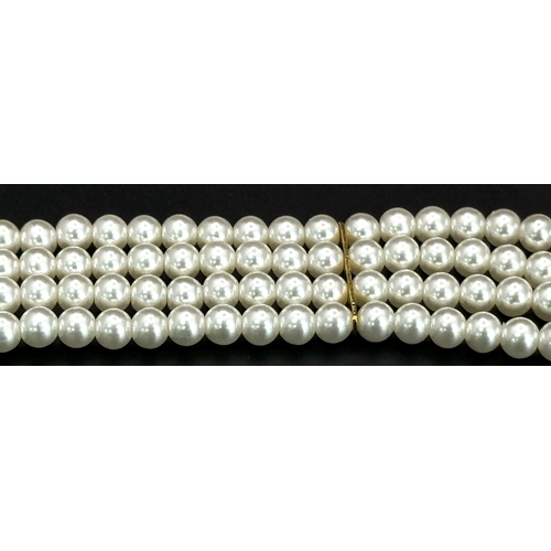 1380 - A very feminine and stylish PIERRE CARDIN three strand faux pearl chocker necklace with a very ornat... 