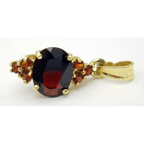 1455 - A Vintage 18 Carat Yellow Gold Bohemian Garnet Pendant. 2.3 cm Length. Set with a 1cm Long Oval Cut ... 