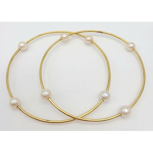 827 - A Pair of 18K Yellow Gold Bangles with Orbiting Pearl Decoration. 6cm inner diameter. 13.1g total we... 