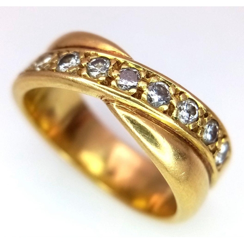 722 - An 18K Yellow Gold Diamond Crossover Ring. 0.30ctw of round cut diamonds. Size M 1/2. 7.9g total wei... 