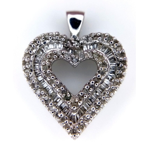 918 - A 14K White Gold and Diamond Heart Pendant. Pierced central heart with baguette and round cut diamon... 