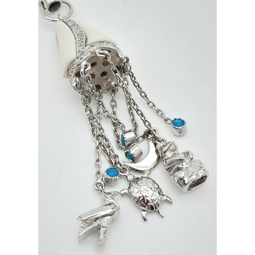 981 - A Vintage 18K White Gold, Diamond, and White Enamel Hanging Charm Pendant. Includes duck, bear, turt... 