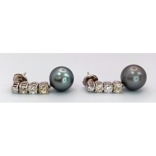 883 - A Pair of 18K White Gold, Diamond and Large Grey Pearl Drop Earrings. 1.6ctw of brilliant round cut ... 